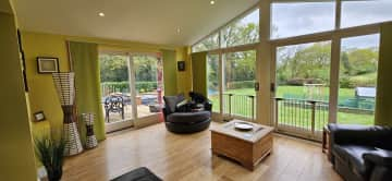 Our beautiful sunroom, with views of the woods and fields.