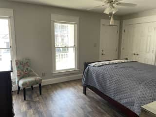 Large guest room with fresh paint and new flooring. Private bath across the hall.