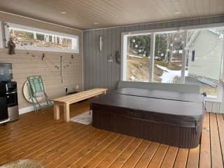 Ard Na Mara hot tub and sitting area with outside furniture.