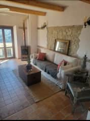 Living room lounge with wood burning stove.