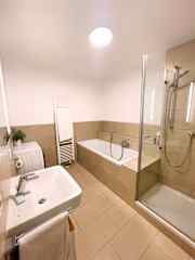 Main bathroom with full sized bath, large shower and washing machine