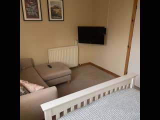 Sitting area in bedroom with TV.