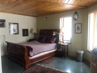 Master bedroom with Its own three piece bathroom. There's a door to the outside where there is currently a temporary secure yard to let my dogs out in the night.