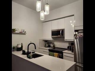 Renovated kitchen with microwave, kettle, air fryer, toaster, dishwasher.