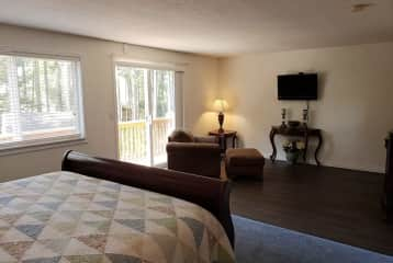 Primary Bed with balcony and view of trees