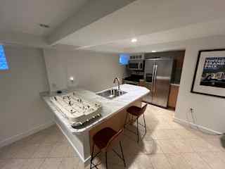 Fill kitchen in guest suite (with hockey foosball!)