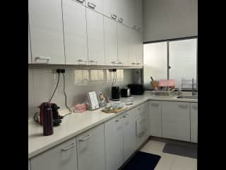 Inside dry kitchen - sink, fridge, coffee machine, microwave and food storage