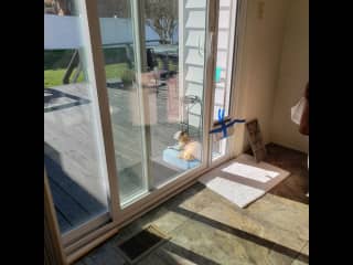 Sunroom with outside deck.  There is an umbrella to open when the weather is nice as well as electric grill and table with chairs.