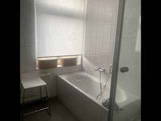 Bathroom has a tub and a shower
