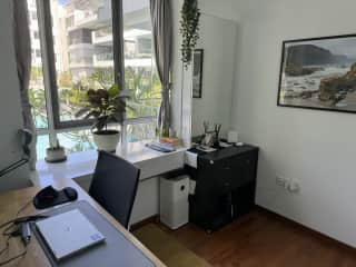 Home office set up with curved monitor and adjustable standing desk