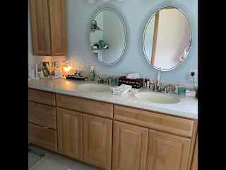 Main level bathroom with shower and two sinks. No bathtub in home. Bath with shower on lower level as well.