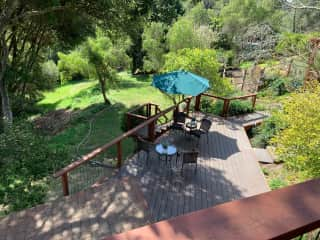 looking down onto another deck and our lawn and fruit trees