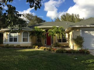 House.  (Older photo) currently 5 productive coconut palms line driveway.