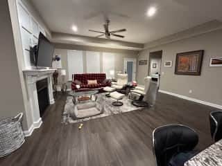 Open Concept living room with gas fireplace and exit to large covered patio