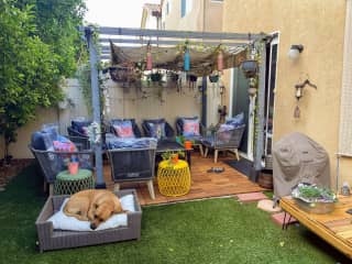 Our backyard with a shaded gazebo and a grill