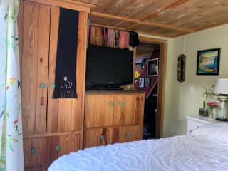 Roku TV and small dresser and closet in the main bedroom