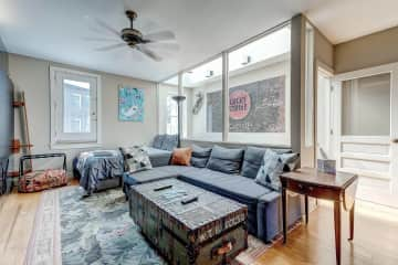 3rd floor TV room/office area. The sofa pulls out to a bed. The bed in the photo is no longer there. Standing height desk with high chair to the right outside of shot.