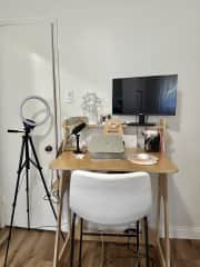 Standing desk with ring light, microphone, and external moniter