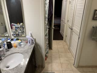 View of the bathroom looking towards bedroom. Shower/tub is on the left.