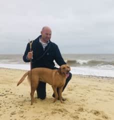 Matthew on the beach in Southwold with Bibi on a house sit.
