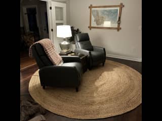 Reading room with recliners facing a wood stove.