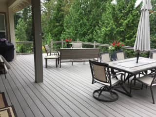 Back deck faces beautiful wooded green belt.