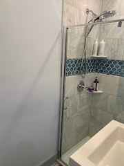 Full downstairs bath with beautifully tiled shower and bench