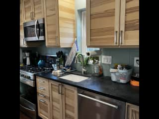 Kitchen with gas stove, microwave, dishwasher and more.