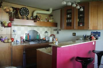 Fully-equipped kitchen with granite counters, combi-oven, gas cooktop, fridge + dishwasher