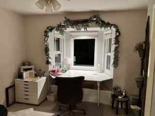 Office space has a bay window looking out on the garden and family orchard.