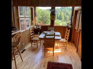 our dining room overlooking a valley and redwoods, door opens onto a deck