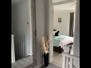 Hallway leading to both bedrooms and bathroom