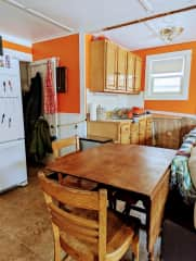 Dining table and sink looking to basement door where washer and dryer are located. These are shared with the front unit.