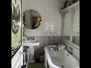 Main upstairs bathroom with walk in shower to the left of the hand basin.