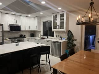 Kitchen and dining area. Walk out onto an expansive deck! Brand new appliances and stone countertops.