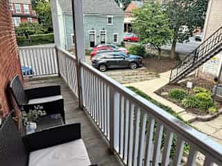 My apartment is downtown, but set away from the street so my balcony surroundings are super quiet and peaceful. The included parking spot is where the red car is parked. Laundry building is a little beyond what you see here.