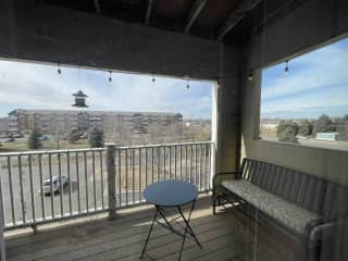 Balcony with rocking bench and bistro tables (there are chairs but not pictured)