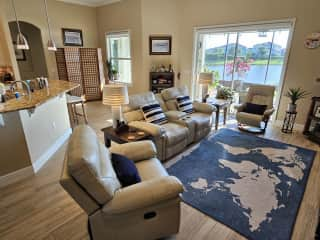 Living room.  The two recliners in the love seat are electric, with moveable headrests and USB charging ports.  The other two recliners are manual.  There are also wireless charging pads on each end table.