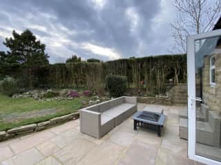 Patio with furniture and barbeque in good weather.