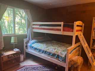 Our second bedroom has a full bed (Avocado) and a twin bed (European Sleepworks), all natural bedding, gorgeous area rug, blackout curtains, and views of the forest.