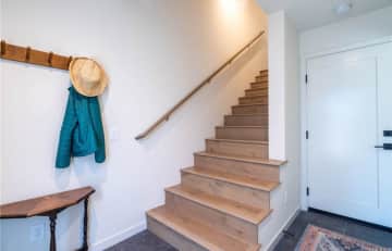 Entry way. Door on right is garage, front door is behind the picture taker, stairs up to 2nd floor which is the kitchen and living room.