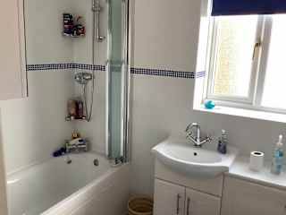 Bathroom with over bath shower