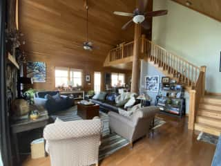 Living room looking toward staircase and upstairs loft that leads to two bedrooms and a full bath.