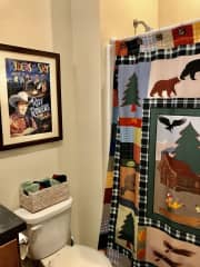 Full bath has Western decor.