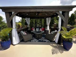 Outdoor gazebo with fire pit, fans and Alexa music.