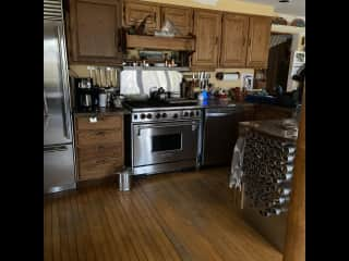 Another view of kitchen. Subzero fridge and Wolf range. Dishwasher, microwave, countertop convection oven, toaster, coffee maker