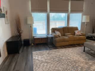 This is our open family room with 75" tv screen, views of the patio and greenbelt and open to the kitchen and dining room