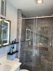 En suite bathroom with shower and natural light.