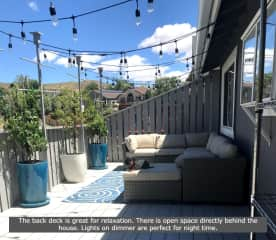 The back deck is great for relaxation. There is open space directly behind the house. Lights on a dimmer are perfect for night time. That's Kaiya sitting on the foot rest of the comfy sectional.