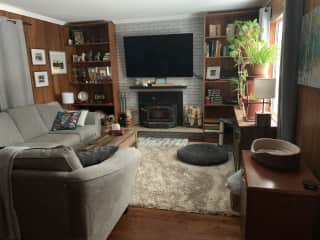 Living room with fireplace and 70 in Smart TV